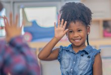 Kindergarten students playing a silent game in class