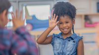 Kindergarten students playing a silent game in class