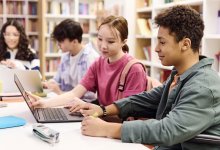 Students doing research in a library together