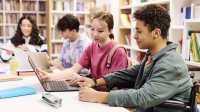 Students doing research in a library together