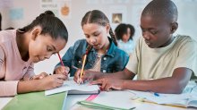 A group of elementary students engaged and working collaboratively