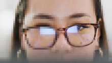 image of a pixelated woman with glasses with one eye free of the digital artifacting