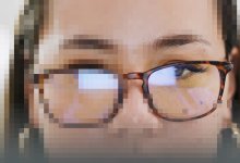 image of a pixelated woman with glasses with one eye free of the digital artifacting
