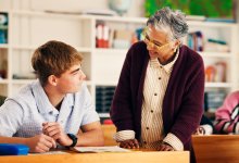 Middle school teacher working with a student