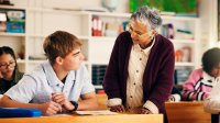 Middle school teacher working with a student