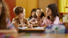 Two elementary students working together on a writing assignment
