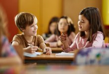 Two elementary students working together on a writing assignment