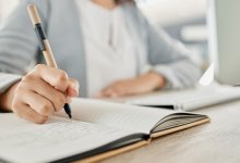 Person writing down a list in a notebook