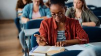 High school students reading books for research purposes