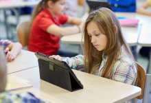 Elementary student working on a tablet in class