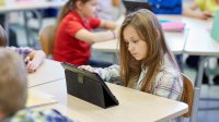 Elementary student working on a tablet in class