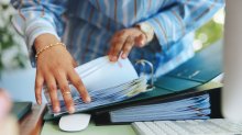 Someone rifling through documents in a portfolio