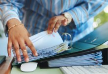 Someone rifling through documents in a portfolio