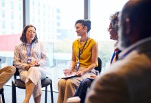 Administrators sitting and discussing in a support circle