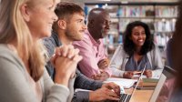 A group of parents and teachers having a meeting in a library about AI policies