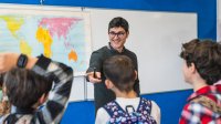 Teacher talking to students before they leave class