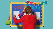 photo of a teacher taking down a bulletin board after the last day of school