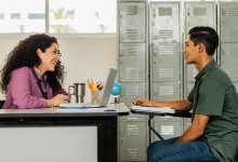High school teacher and student meeting one-on-one