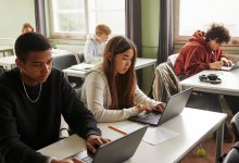 High school students working on laptops in class