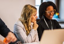 Two women in discussion during a meeting