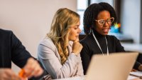 Two women in discussion during a meeting
