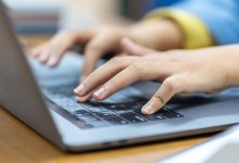 Student typing on a laptop