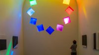 Interior of Ellsworth Kelly's AUSTIN at Blanton Museum, Austin, TX as visitor admires stained glass.