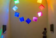 Interior of Ellsworth Kelly's AUSTIN at Blanton Museum, Austin, TX as visitor admires stained glass.