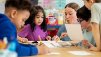 Elementary students forming sentences based on a wordless picture book