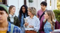 A teacher leading her class on a tour of a public area outside the school