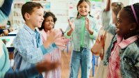 Elementary students standing in a circle playing an icebreaker game