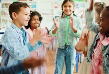 Elementary students standing in a circle playing an icebreaker game