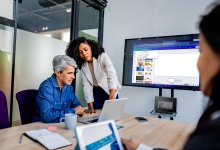 a photo of a tech professional training educators on a tool