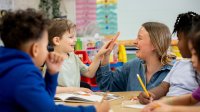 Elementary teacher giving a student a high five