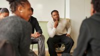 High school teacher leads a student group discussion