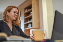 An administrator working on her laptop