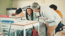 A teacher encouraging a shy student in class