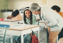 A teacher encouraging a shy student in class