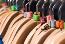 Clothes hangers displaying a range of school uniform sizing