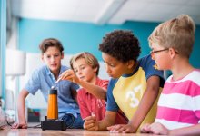 Elementary students carefully observing a science experiment