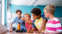 Elementary students carefully observing a science experiment