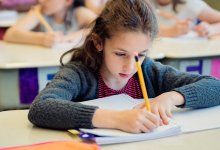 A classroom of elementary students writing in a journal