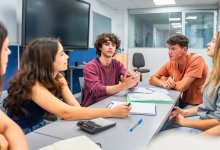High school students listening intently to one of their group members