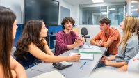 High school students listening intently to one of their group members