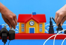 Hands unplugging an overloaded school-shaped power strip