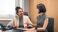 Two coworkers involved in a thoughtful discussion