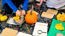 Elementary students working on a fall pumpkin project