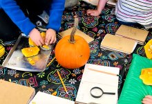 Elementary students working on a fall pumpkin project