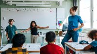 Elementary students performing in front of their class