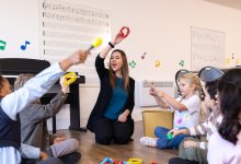 Elementary music teacher leading students in instrument play